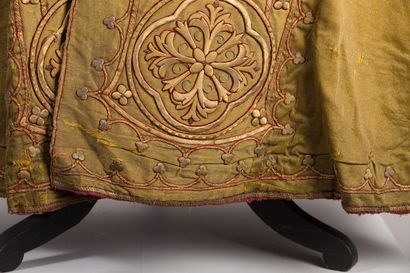 null Cape with rich embroidered decoration on a golden yellow background.

The hood...