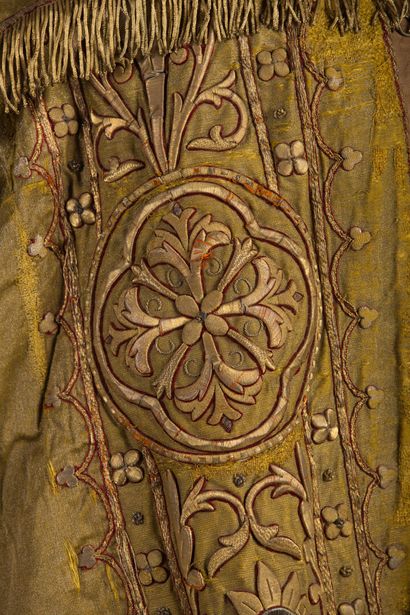 null Cape with rich embroidered decoration on a golden yellow background.

The hood...