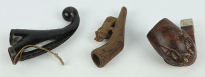 null Collection of nine wooden pipe stoves carved with animals and characters.

L_7...