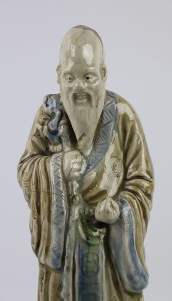 null CHINA.

Enamelled stoneware statuette representing Shou-Lao holding the peach...