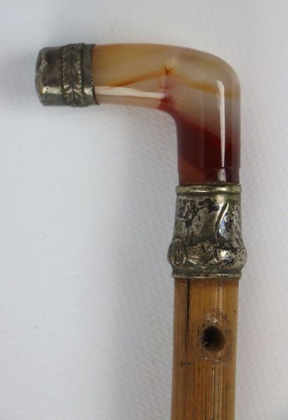 null Cane, the pommel in agate, mounted in embossed and chased silver, the shaft...