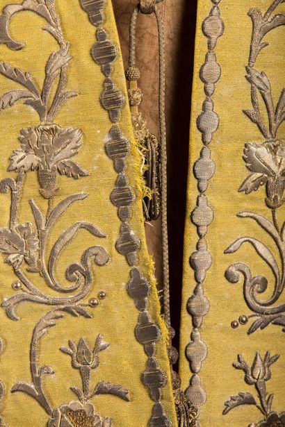 null Stole decorated with embroidery on a yellow background, two tears in the li...