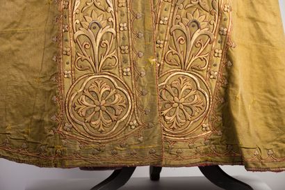 null Cape with rich embroidered decoration on a golden yellow background.

The hood...