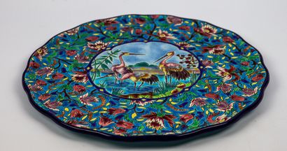 null LONGWY.

Earthenware dish with polychrome enamel decoration of three birds in...