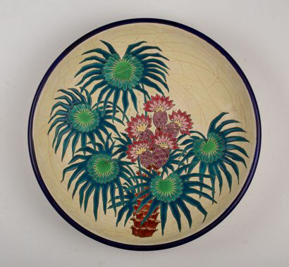 null LONGWY.

Earthenware dish decorated with polychrome enamels featuring pineapples...