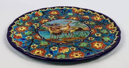 null LONGWY.

Earthenware dish decorated in polychrome enamels with three birds in...