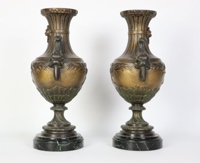 null Paire de vases balustres en bronze à patine brune, les anses à décor de dauphins.

Le...