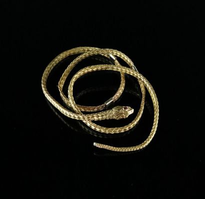 null Bracelet en or jaune figurant un serpent orné de deux pierres rouges formant...