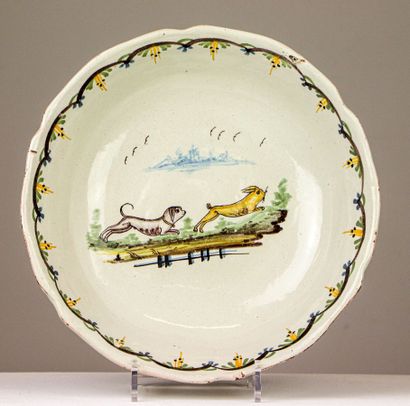 null NEVERS.
Earthenware salad bowl with polychrome decoration of a dog chasing a...