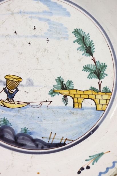 null NEVERS. 
Earthenware plate with polychrome decoration of a fisherman with a...