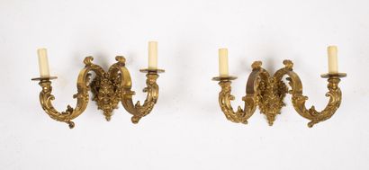 null Suite of four bronze sconces with two lights, the arms supported by a mask of...