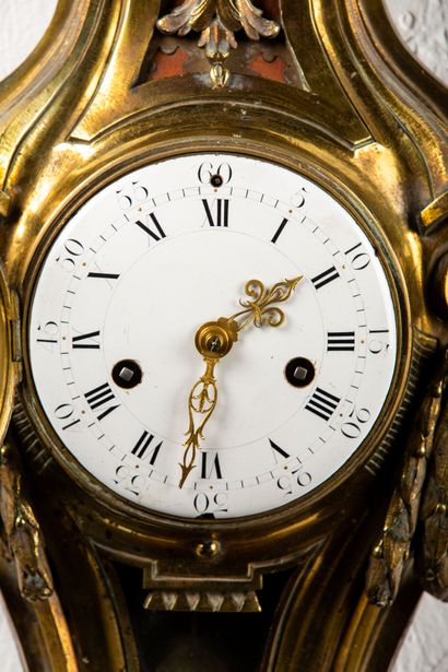 null Wall clock in chased and gilded bronze decorated with garlands and vase at the...