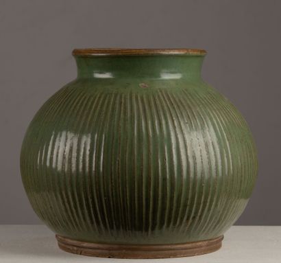 null CHINA.
A celadon glazed porcelain vase with a straight neck, decorated with...