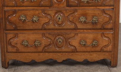null Parisian chest of drawers in light oak, molded and carved, opening to four drawers...