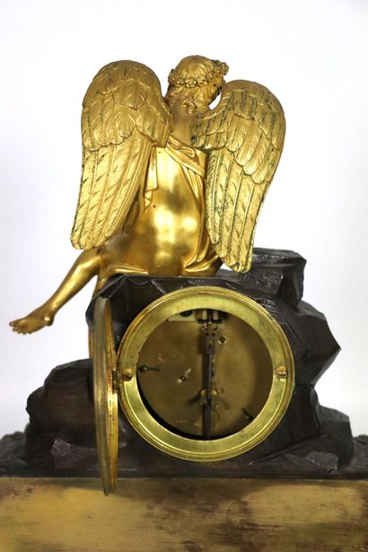 null Gilt bronze and brown patina bronze clock featuring Love approaching a butterfly...
