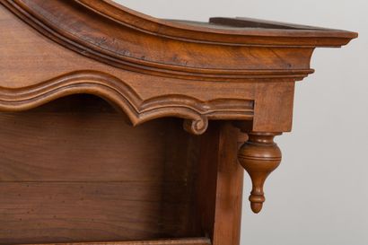 null Vaisselier in molded and carved walnut, opening with leaves and drawers in the...