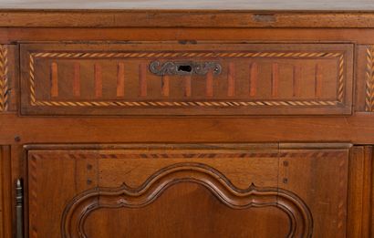 null Vaisselier in molded and carved walnut, opening with leaves and drawers in the...