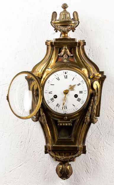 null Wall clock in chased and gilded bronze decorated with garlands and vase at the...