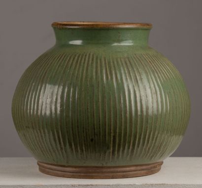 null CHINA.
A celadon glazed porcelain vase with a straight neck, decorated with...