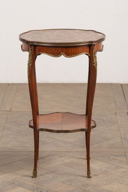 null Living room table in rosewood veneer, the top in red marble, ormolu ornamentation.
Louis...