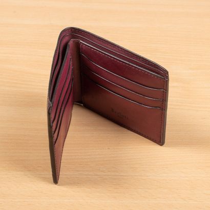 null BERLUTTI. 
Wallet in burgundy calf leather. 
Six slots for credit cards and...