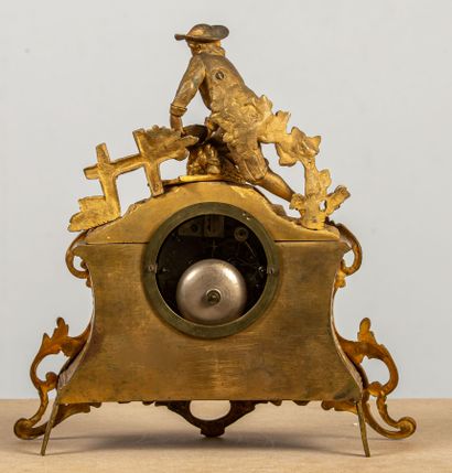 null Romantic clock in gilt bronze, featuring a young peasant collecting vegetables.
White...