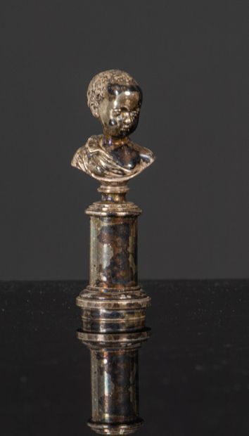 null Silver-plated bronze seal, depicting a bust of a young Nubian on a column.
Figured.
Second...