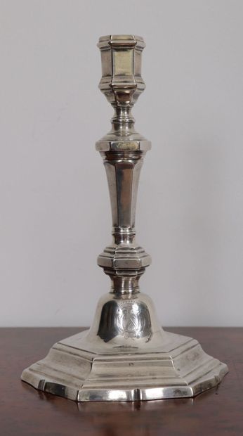 null Pair of silver candlesticks.
The bases decorated with coats of arms under a...