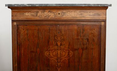 null Secretary desk in rosewood veneer and rich light wood marquetry.
It opens with...