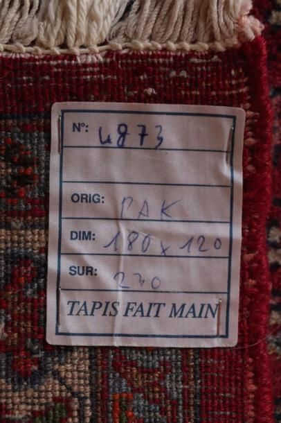null Tapis pakistanais en laine à fond rouge.

L_180 cm l_120 cm.