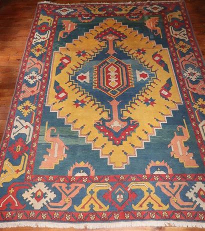 null Important tapis en laine polychrome à décor de motifs stylisés sur champ bleu,...