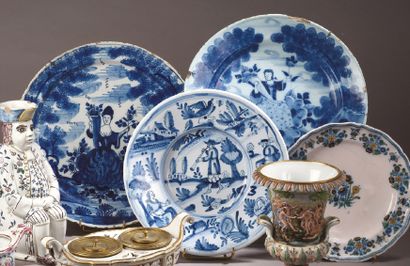 DELFT Two round earthenware dishes decorated in blue monochrome with a figure of...