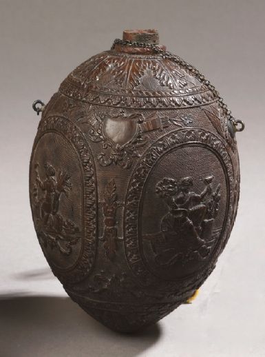 null COCO NUT carved with decoration of ancient gods in medallions on a background...