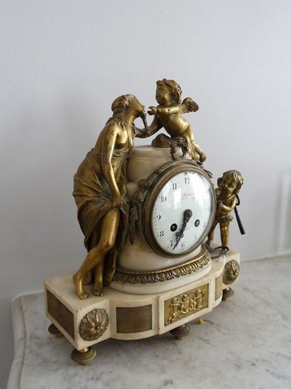 null White marble and bronze terminal clock decorated with a nymph and two loves.

Louis...