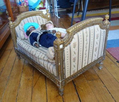 null Doll's bed in gilded wood with gadroons and interlacing decoration, resting...