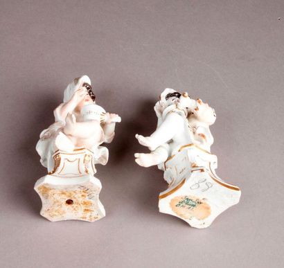 MEISSEN Two porcelain statuettes depicting winter in the guise of a young boy sitting...