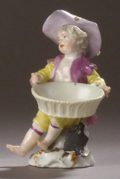 MEISSEN Porcelain statuette representing a young boy sitting, holding a basket on...