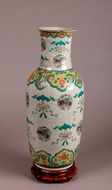 null Porcelain baluster VASE with polychrome decoration on a beige cracked background...