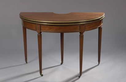 null Mahogany BOUILLOTTE TABLE in half moon shape, resting on tapered fluted legs...