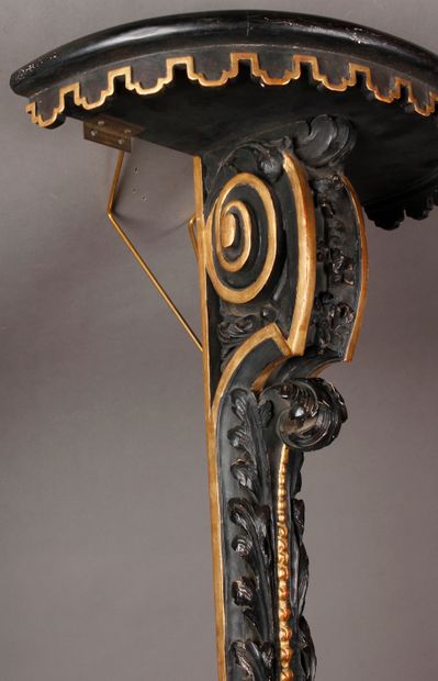 null A small blackened wood and gilded net wall console, with lambrequin decoration,...