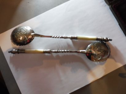 null Pair of oval serving spoons with hemmed edge, pierced bottom, long stem with...