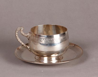 null A silver cup with handle and its silver SUB-CUP with incised decoration of laurel...