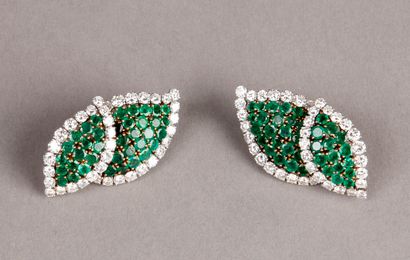 null PAIR OF EAR CLIPS representing two leaves paved with round emeralds and bordered...
