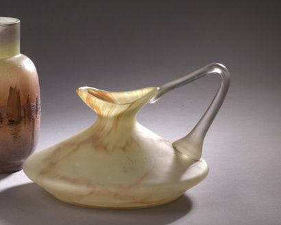 DAUM Nancy A brown-beige marmorated glass JUG with a flared neck and flattened body....