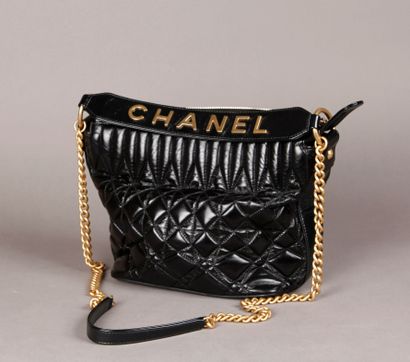  CHANEL, Made in Italy. Black quilted calfskin shoulder bag, gold metal trim (wear)....