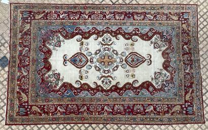 null Tabriz. Wool carpet with central medallion decorated with portraits in reserves...