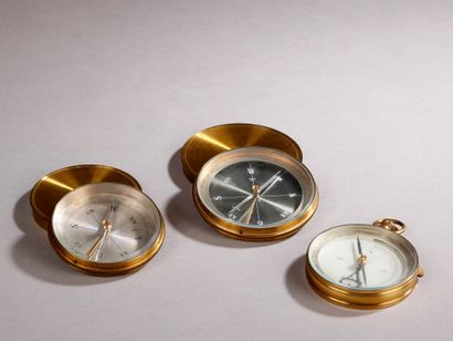 null Three brass compasses, two with cover and one in the form of a pocket watch....