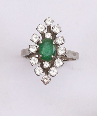 null Marquise ring set with an oval emerald (chips) in a circle of diamonds. White...