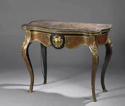null PLAY TABLE in marquetry of tortoiseshell and brass, of moved form, resting on...