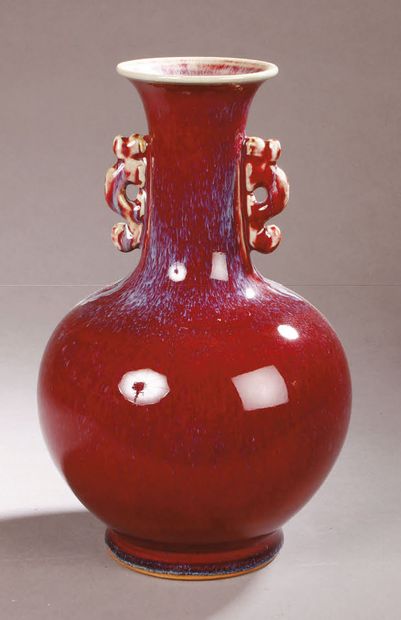 null A long-necked vase with handles in the shape of stylized dragons in porcelain...